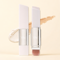 VAIRE BEAUTY color changing foundation stick with brush on warm ivory studio background