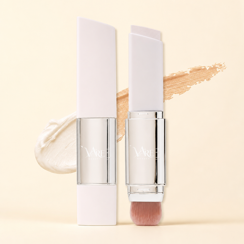 VAIRE BEAUTY color changing foundation stick with brush on warm ivory studio background